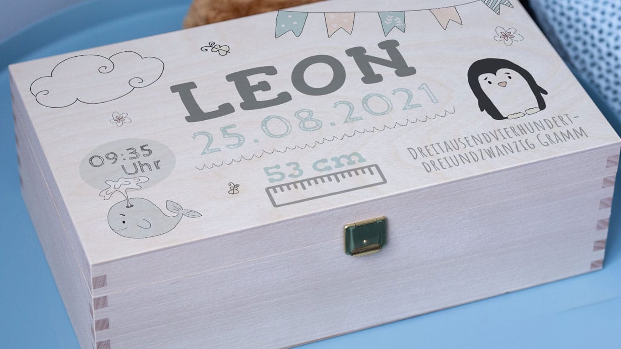 Une boîte en bois avec un gaufrage personnalisé et des motifs de bébé.